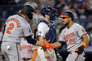 Henderson and Santander celebrate home run