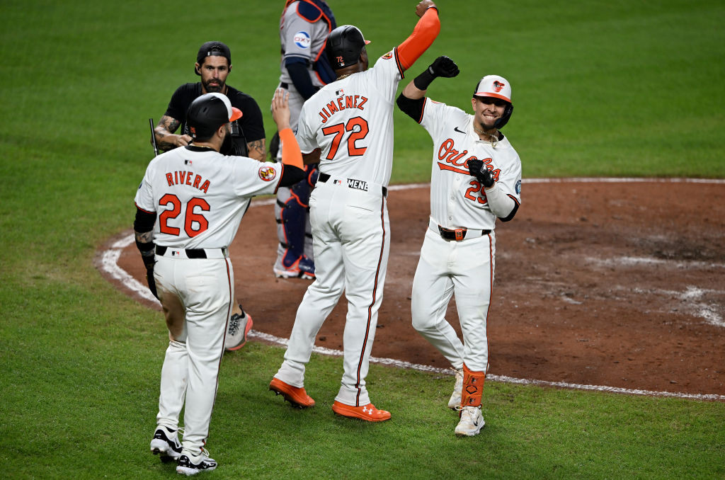 Urias celebrates hr with Jimenez and Rivera